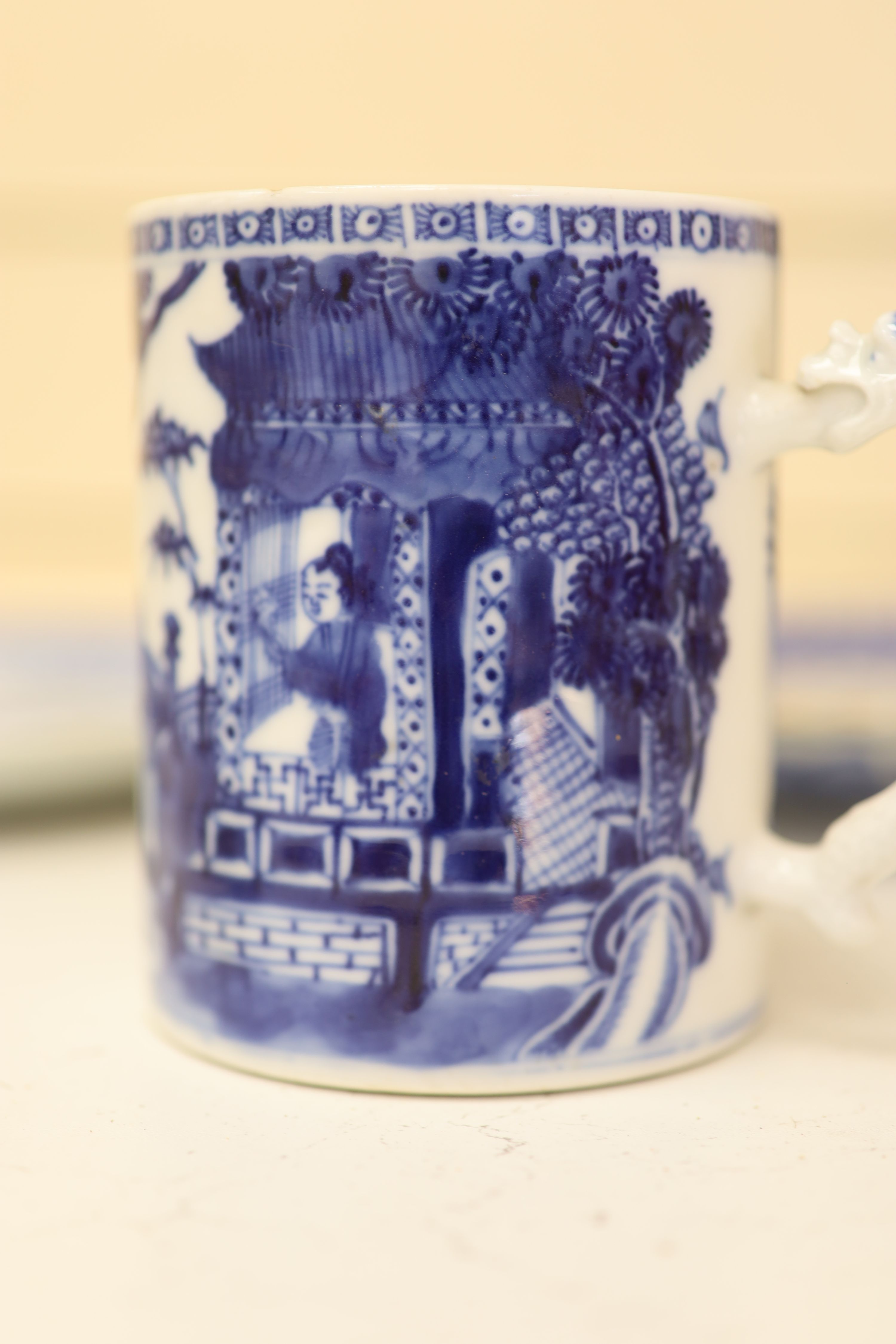 An 18th century Chinese blue and white mug and cup, a 19th century Chinese blue and white plate and a Japanese plate